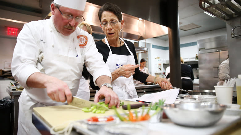 two chefs cutting ingredients