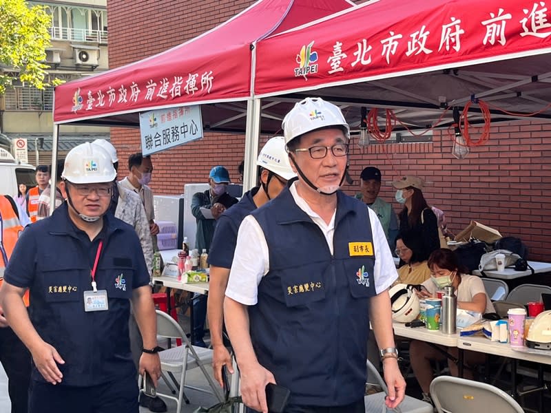 北市副市長李四川（右）今至大直民宅陷落現場視察，表示若結構安全，下沉棟25戶有望明天可回家拿貴重物品，不過還需開會討論。（中央社）
