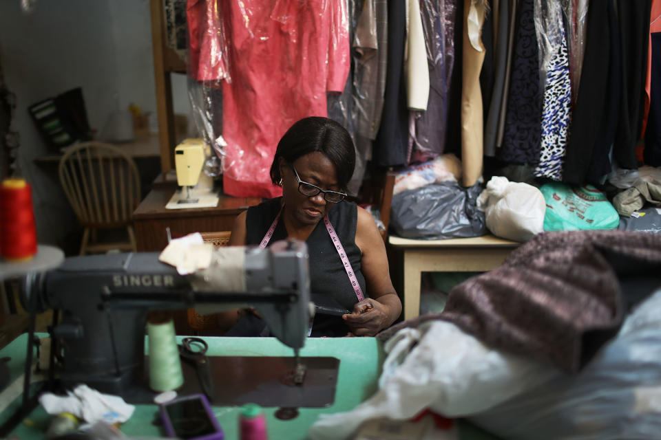 Juliette Virgile works in the tuxedo store in the Little Haiti neighborhood, Miami, which has been in her family for 32 years. Little Haiti and surrounding neighborhoods are experiencing gentrification, which is slowly pushing out some of the longtime residents and business owners. (Photo: Joe Raedle via Getty Images)