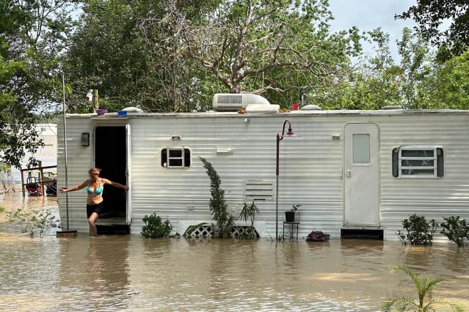 A woman steps out of a mobile home in an unincorporated area in east Harris County near Houston on Saturday afternoon (AP)