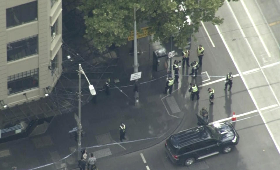 This image made from video shows police on street corner after a shooting in Melbourne, Australia, Friday, Nov. 9, 2018. Police shot a knife-wielding man Friday after he fatally stabbed one person and injured two others in the center of Australia's second-largest city, police said. (Australian Broadcasting Corporation via AP)