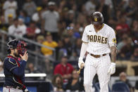 San Diego Padres' Manny Machado, right, reacts after being called out on strikes as Atlanta Braves catcher Travis d'Arnaud looks on in the 10th innings of a baseball game Saturday, Sept. 25, 2021, in San Diego. (AP Photo/Derrick Tuskan)