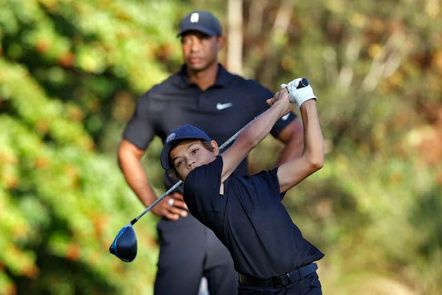 Charlie Woods tees off as his father Tiger Woods watches 