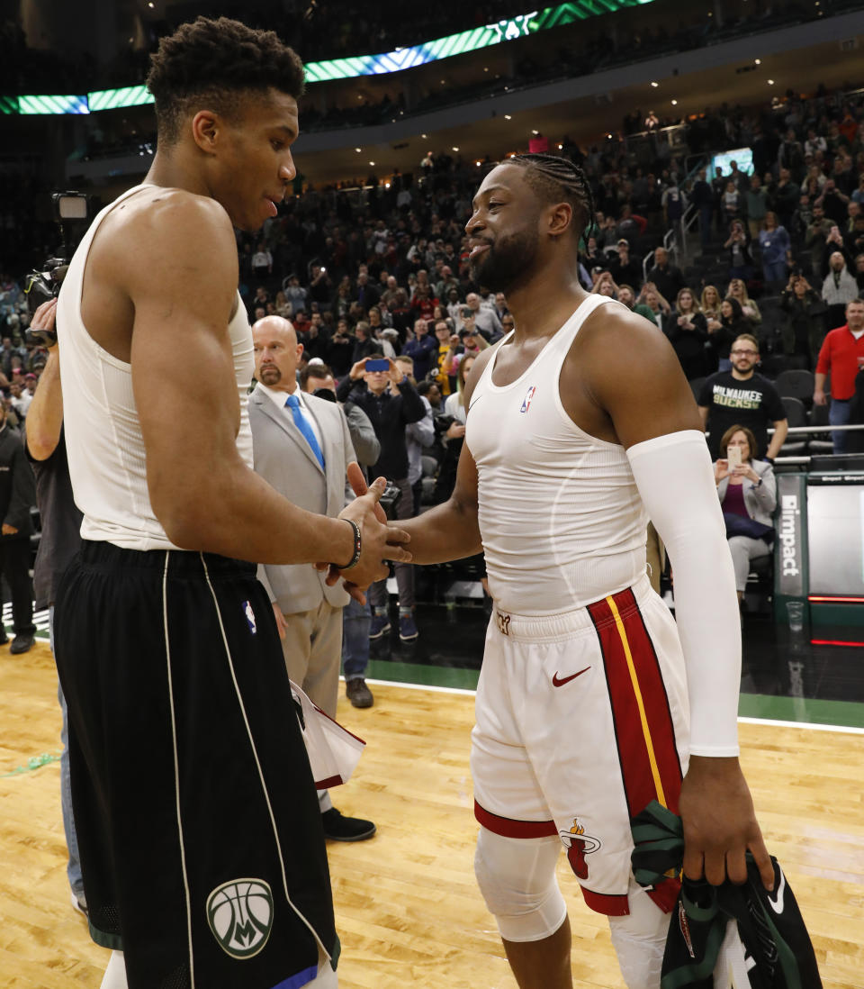 Milwaukee Bucks' Giannis Antetokounmpo, left, and Miami Heat's Dwyane Wade shake hands after an NBA basketball game Friday, March 22, 2019, in Milwaukee. (AP Photo/Jeffrey Phelps)