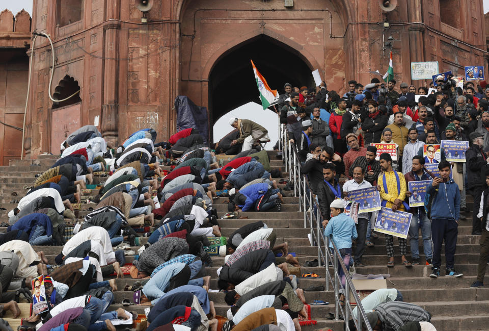 Indian Muslims offer prayers, as activists of Bhim Army wait for the start of a protest against a new Citizenship law, in New Delhi, India, Friday, Jan. 17, 2020. Protests against India's citizenship law that excludes Muslim immigrants continue in Indian cities in an unabating strong show of dissent against the Hindu nationalist government of Prime Minister Narendra Modi. The protest at a 17th century mosque, Jama Masjid, was led by Chandrashekhar Azad, leader of the Bhim Army, a political party of Dalits who represent Hinduism's lowest caste. (AP Photo/Manish Swarup)