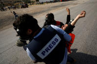 <p>A wounded Palestinian is evacuated during a protest marking the 70th anniversary of Nakba, near the Jewish settlement of Beit El, near Ramallah, in the occupied West Bank, May 15, 2018. (Photo: Mohamad Torokman/Reuters) </p>