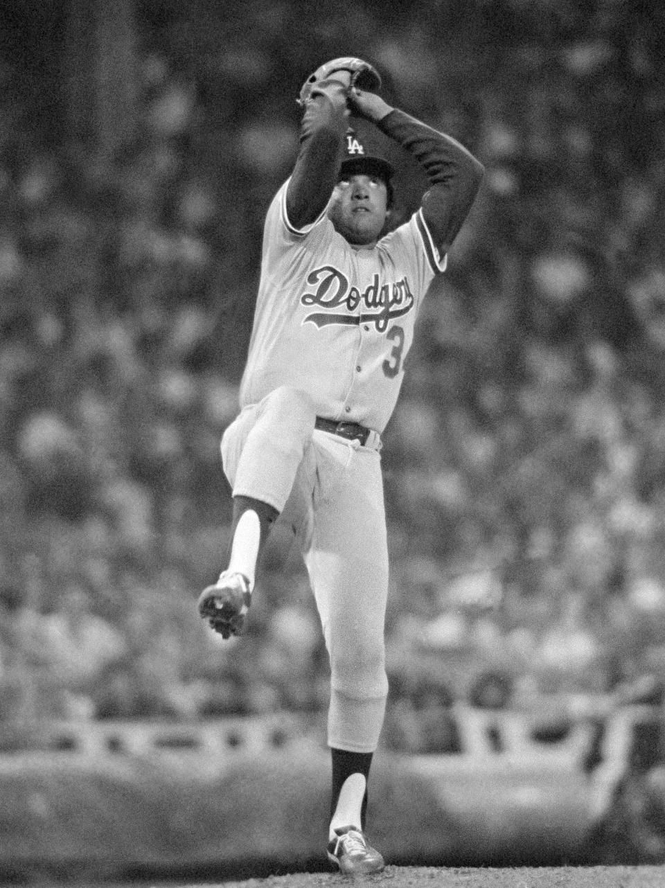 FILE - In this Aug. 8, 1981, file photo, Los Angeles Dodgers pitcher Fernando Valenzuela pitches in the All-Star game in Cleveland. The Dodgers needed a strike interrupted season and a pitching sensation named Fernando Valenzuela to win a championship in 1981. More important for the Dodgers, perhaps, is that they found a way that year to connect with Hispanic fans who nearly four decades later are still loyal supporters of the team. Author Jason Turbow tells PodcastOne Sports Now that the season was significant in many ways for the Dodgers, something he details in his new book ``They Bled Blue,'' a recap of a season like no other.(AP Photo/File)