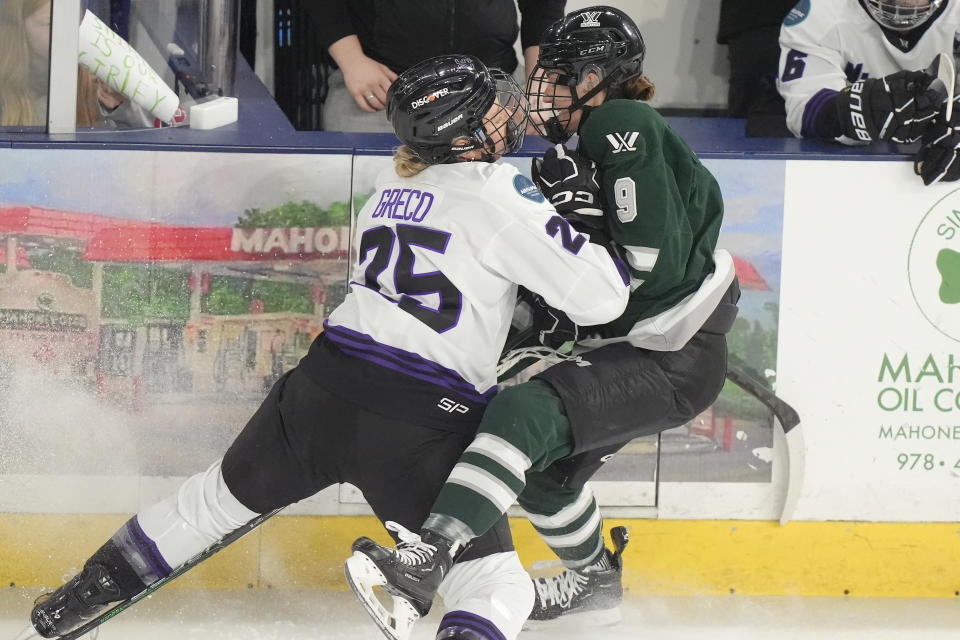 Minnesota defenseman Emma Greco, left, collides with Boston forward Sophie Shirley, right, during the first period of Game 1 of a PWHL hockey championship series, Sunday, May 19, 2024, in Lowell, Mass. (AP Photo/Steven Senne)