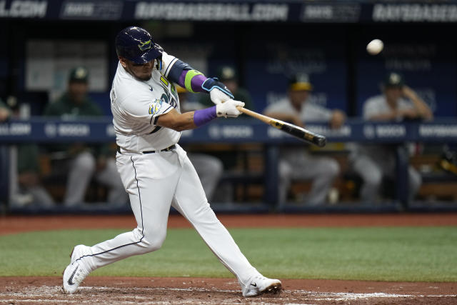 Tampa Bay Rays' Isaac Paredes, right, hits a two-RBI single during the  fourth inning of a baseball game as Oakland Athletics catcher Shea  Langeliers, left, watches Saturday, April 8, 2023, in St.