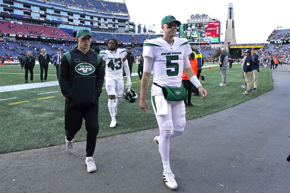 New York Jets quarterback Mike White (5), who replaced the injured Zach Wilson during the first half, heads to the locker room after a 54-13 loss to the New England Patriots following an NFL football game, Sunday, Oct. 24, 2021, in Foxborough, Mass. (AP Photo/Steven Senne)
