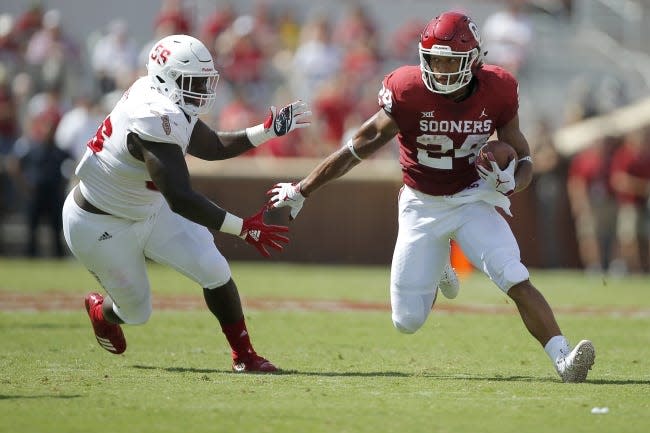 Oklahoma's Rodney Anderson, right, runs past Florida Atlantic's Steven Leggett during a game in Norman on Sept. 1, 2018. [Bryan Terry/The Oklahoman archives]