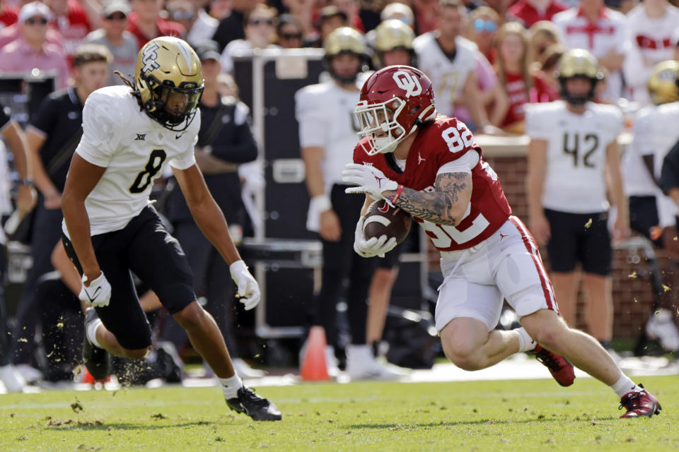 Oklahoma wide receiver Gavin Freeman (82) runs after a catch near UCF defensive back Demari Henderson (8) in the first half of an NCAA college football game, Saturday, Oct. 21, 2023, in Norman, Okla. (AP Photo/Nate Billings)