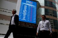 A panel outside the Hong Kong Exchanges displays top active securities in Hong Kong