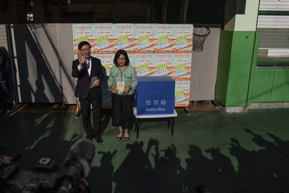 Hong Kong's Chief Executive John Lee, left, and his wife Janet Lam, right, cast their ballot at a polling station during the District Council elections in Hong Kong, Sunday, Dec. 10, 2023. Residents went to the polls on Sunday in Hong Kong's first district council elections since an electoral overhaul was implemented under Beijing's guidance of “patriots” administering the city, effectively shutting out all pro-democracy candidates.(AP Photo/Louise Delmotte)