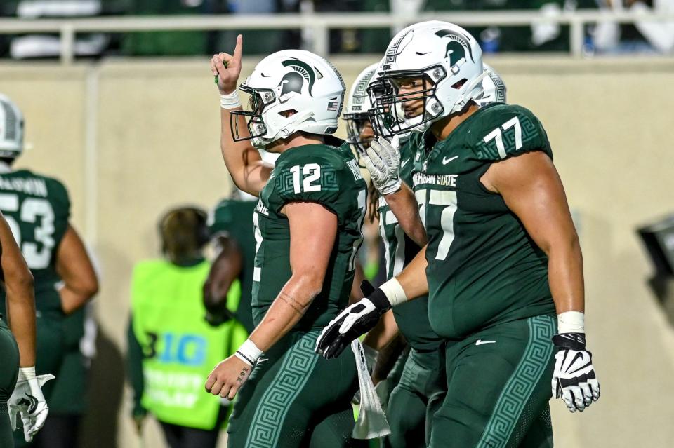 Michigan State's Katin Houser, left, celebrates his rushing touchdown against Washington during the fourth quarter on Saturday, Sept. 16, 2023, at Spartan Stadium in East Lansing.