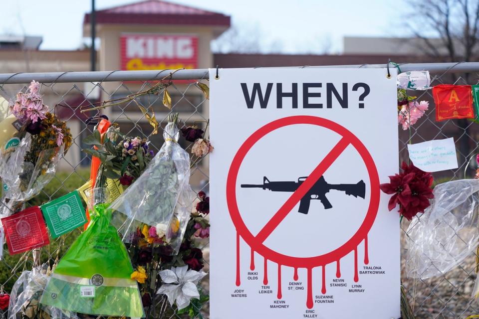 Tributes hang on the temporary fence surrounding the parking lot in front of King Soopers in April 2021 (AP)