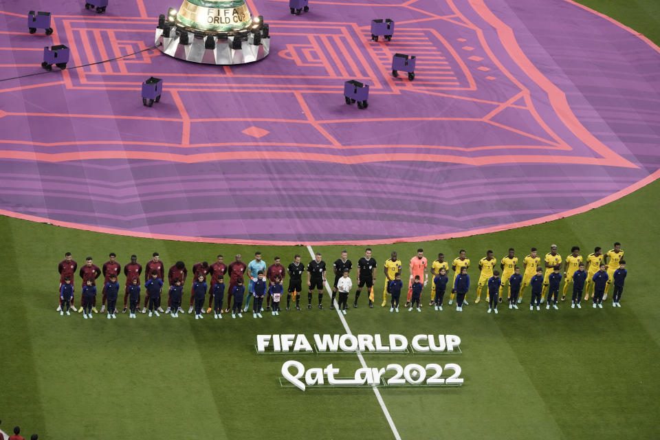 Teams line up before the World Cup group A soccer match between Qatar and Ecuador at the Al Bayt Stadium in Al Khor, Qatar, Sunday, Nov. 20, 2022. (AP Photo/Hassan Ammar)