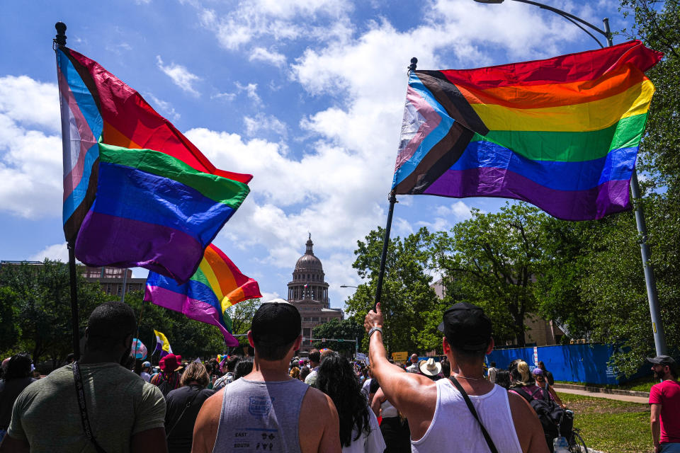 Activists wave progress pride flags as they and hundreds of others march toward the Capitol in a Queer Capitol March on Saturday, April 15, 2023, in Austin. Activists gathered to protest recent anti-LGBTQ legislation in Texas.