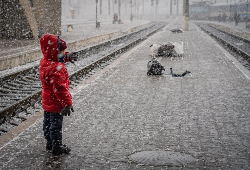 A little boy from Eastern Ukraine waits in the snow for a train to Poland (Bel Trew)