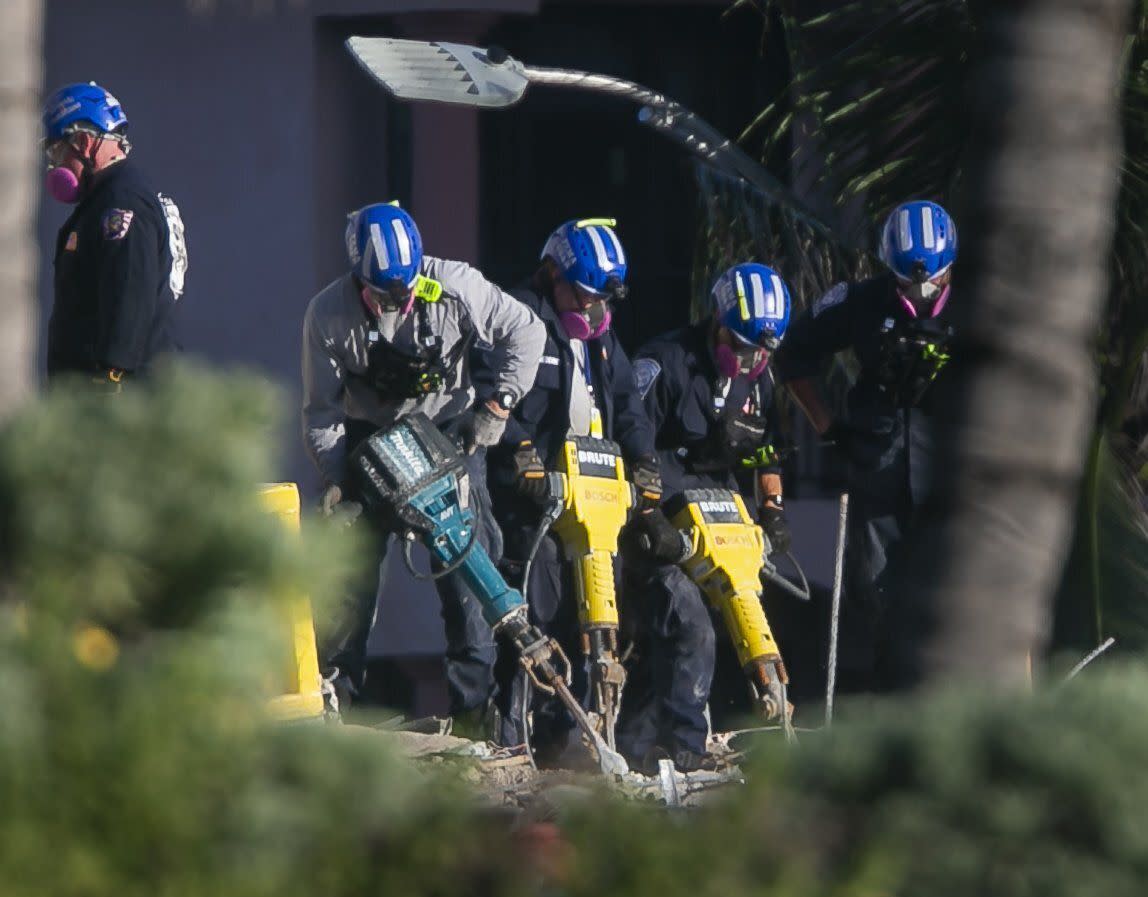 Rescue teams use jack hammers to chip through debris and rubble as they continue to look for survivors at the partially-collapsed Champlain Towers South Condo building in Surfside, Fla. on Saturday, July 3, 2021.