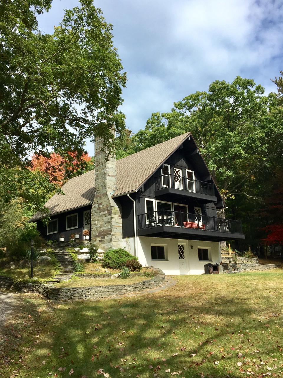 After: Nick worked with a craftsman to replace the balcony railings with thin black metal ones to lighten up the exterior.