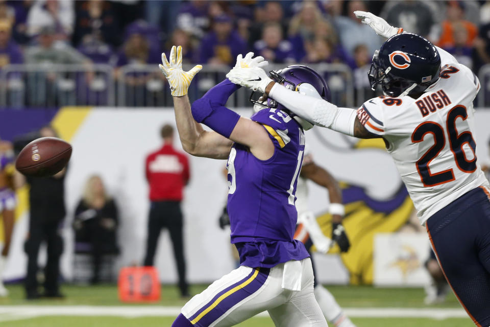 Chicago Bears defensive back Deon Bush (26) grabs the face mask of Minnesota Vikings wide receiver Adam Thielen during the first half of an NFL football game, Sunday, Dec. 30, 2018, in Minneapolis. Bush was called for a penalty on the play. (AP Photo/Bruce Kluckhohn)