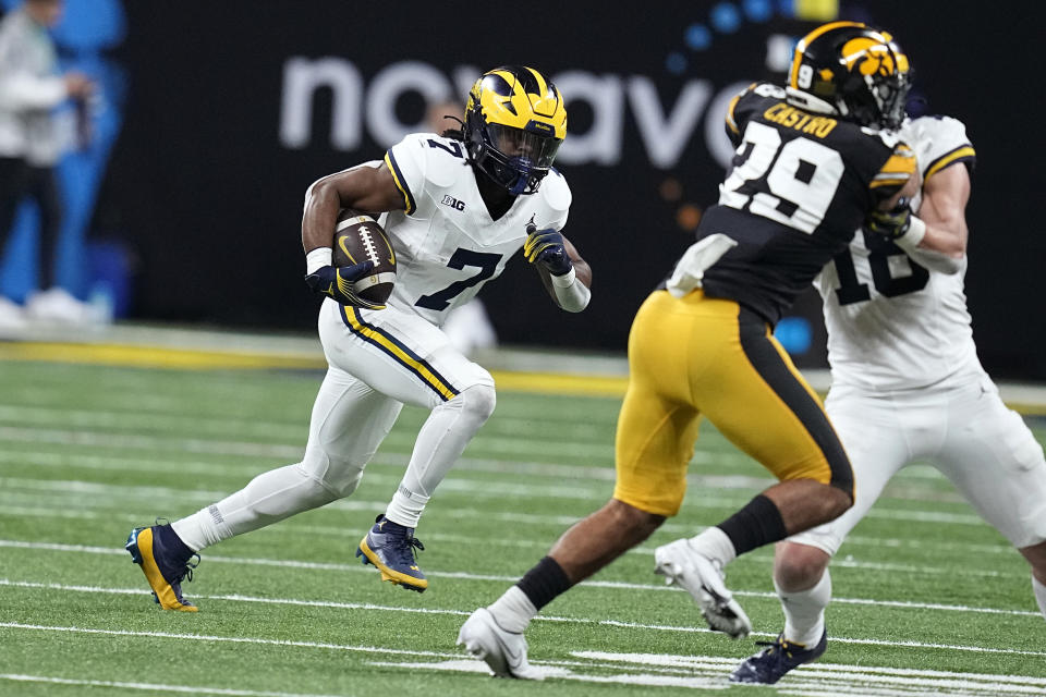 Michigan running back Donovan Edwards (7) runs up field after catching a pass during the second half of the Big Ten championship NCAA college football game against Iowa, Saturday, Dec. 2, 2023, in Indianapolis. (AP Photo/Darron Cummings)