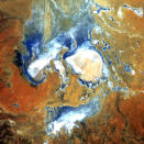 The scary face in this image is actually inundated patches of shallow Lake Eyre (pronounced "air") in the desert country of northern South Australia. An ephemeral feature of this flat, parched landscape, Lake Eyre is Australia's largest lake when it's full. However in the last 150 years, it has filled completely only three times. (Credit: NASA Goddard Space Flight Center/USGS)