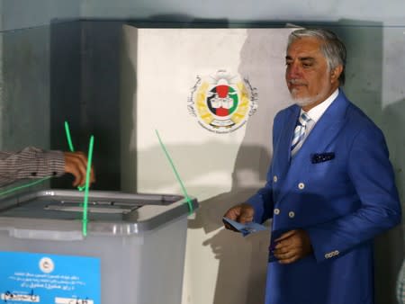 Afghan presidential candidate Abdullah Abdullah arrives to casts his vote at a polling station in Kabul