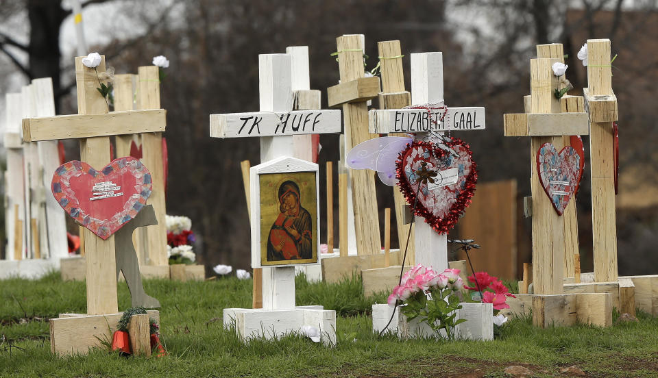 In this Thursday, Feb. 7, 2019, photo, the names of those who died in the Camp Fire are displayed on crosses that make up a memorial in Paradise, Calif. The memorial, along Skyway Road, is a reminder of those who perished in the Nov. 8 blaze that destroyed nearly 15,000 homes in the city of 27,000 residents and surrounding hamlets. (AP Photo/Rich Pedroncelli)