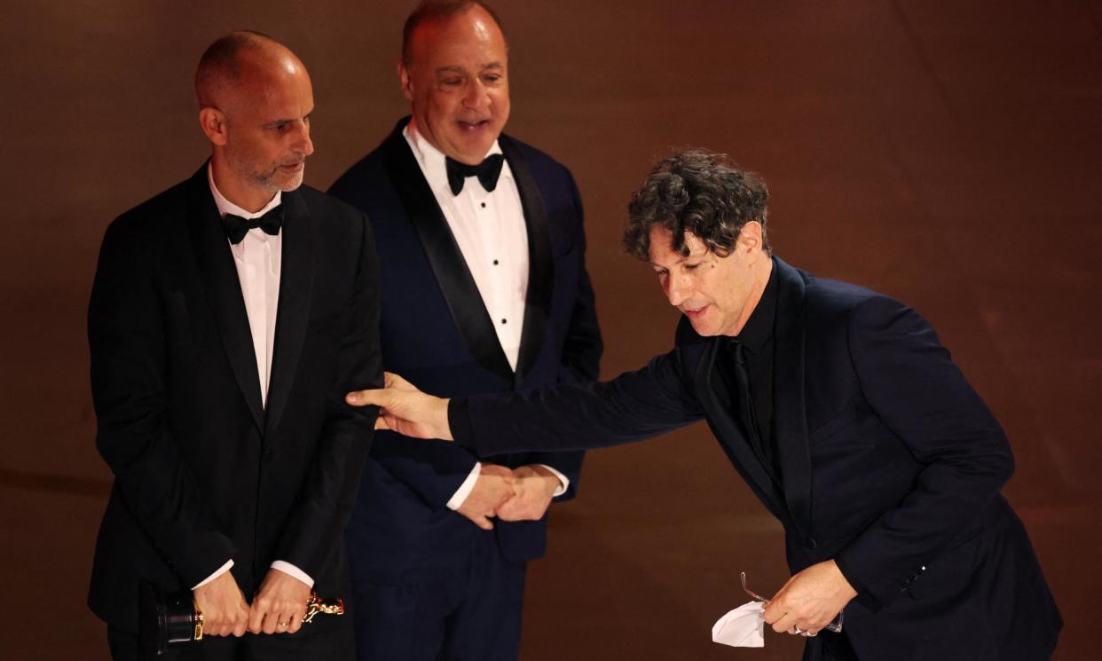 <span>Jonathan Glazer grabs his producer, James Wilson, while winning the Oscar for best international feature film.</span><span>Photograph: Mike Blake/Reuters</span>