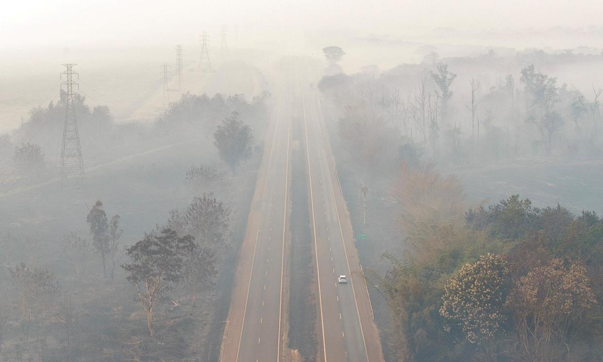 <span>Smoke over a highway in Ribeirão Preto in the north-east of São Paulo state.</span><span>Photograph: Joel Silva/Reuters</span>