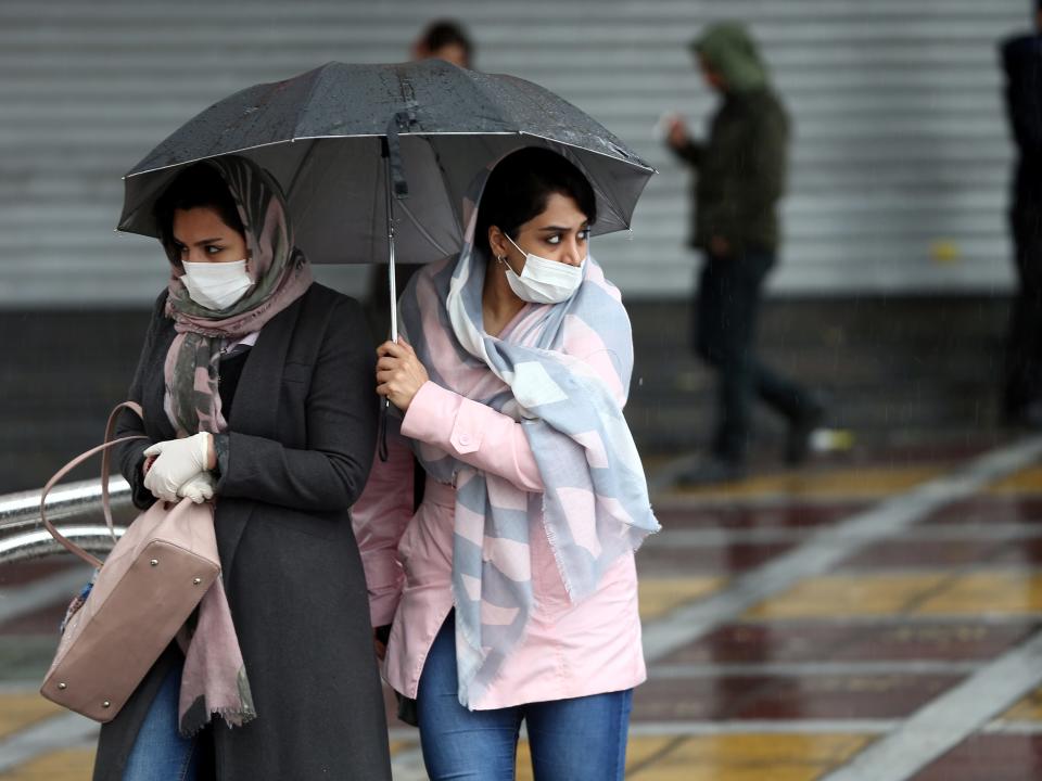 Iranian women wear protective masks to prevent contracting coronavirus, as they walk in the street in Tehran, Iran February 25, 2020. WANA (West Asia News Agency)/Nazanin Tabatabaee via REUTERS