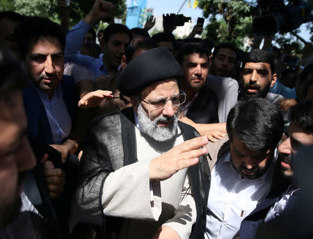 Iranian presidential candidate Ebrahim Raisi (C) arrives with crowds of supporters to cast his vote during the presidential election in Tehran, Iran, May 19, 2017. TIMA via REUTERS