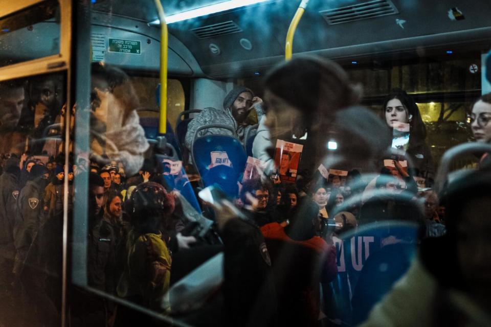 Commuters on a bus watch as their vehicle is held up in traffic congestion.