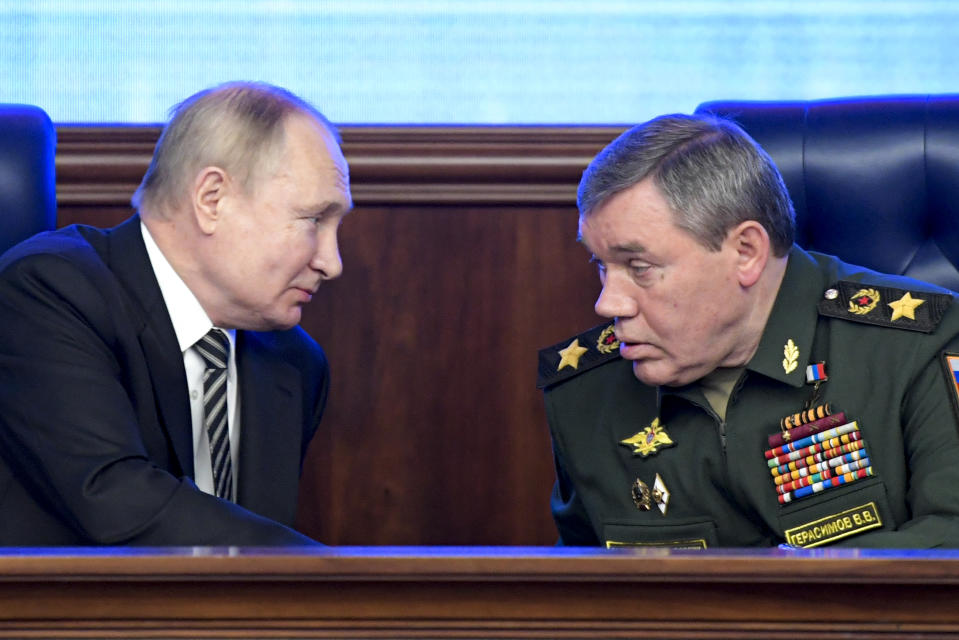 FILE - Russian President Vladimir Put, left, and Russian General Staff Valery Gerasimov talk to each other during a meeting in Moscow, Russia on Dec. 21, 2021. Putin has put Gerasimov directly in charge of Russian forces in Ukraine, a move that some observers saw as an attempt to curtail the influence of Yevgeny Prigozhin, the millionaire owner of the Wagner Group private military company who has publicly criticized the top military brass. (Sputnik, Kremlin Pool Photo via AP, File)