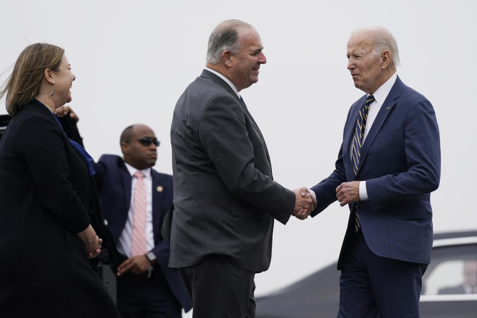 President Joe Biden is greeted by Rep. Dan Kildee, D-Mich., and Rep. Elissa Slotkin, D-Mich., after stepping off Air Force One at MBS International Airport in Freeland, Mich., Tuesday, Nov. 29, 2022. Biden is in Michigan to tour a computer chip factory and speak about manufacturing jobs and the economy. (AP Photo/Patrick Semansky)