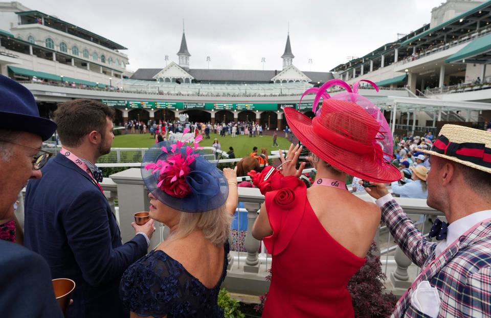 Poeple snap photos inside the Churchill Downs' Paddock before the start of the first race on Kentucky Derby day Saturday, May 4, 2024 in Louisville, Kentucky.