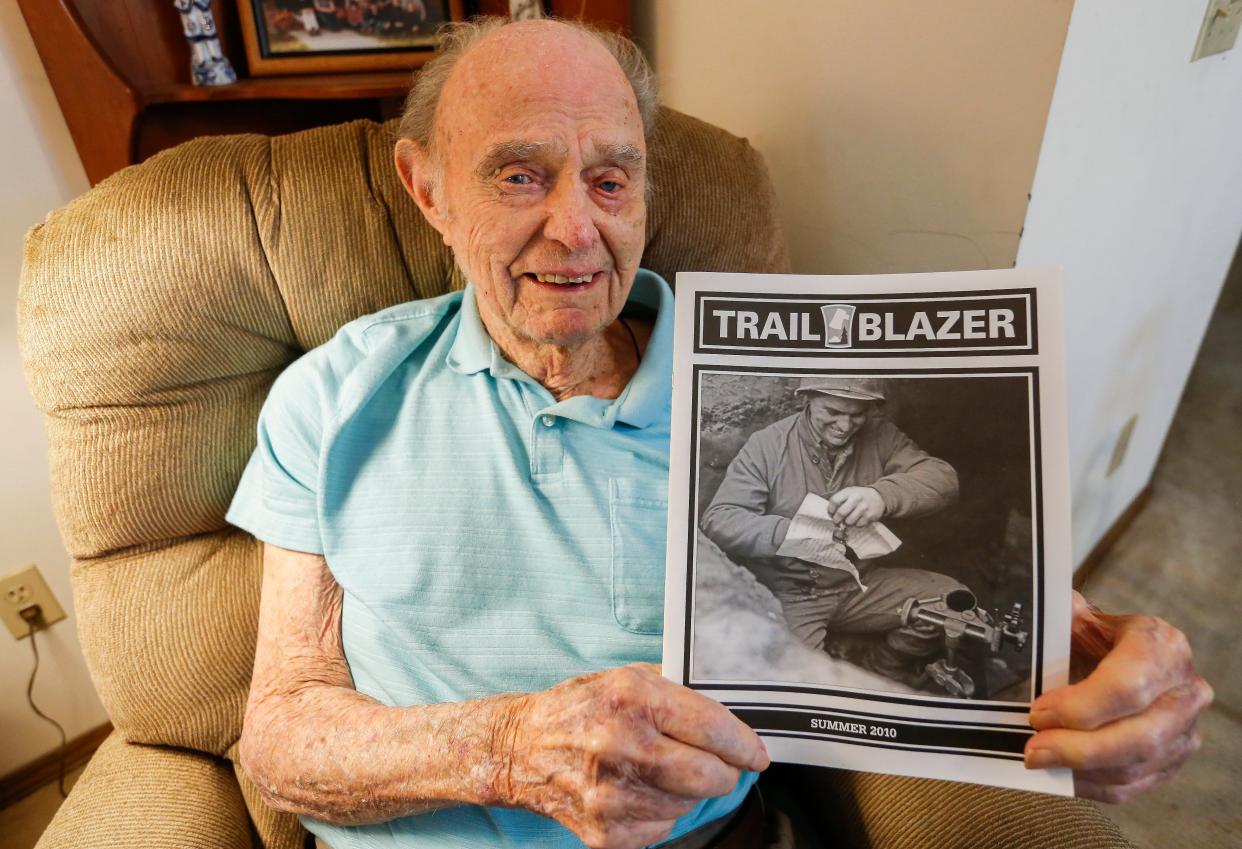 Joe Doyle holds up a magazine with his picture on the cover from his time in he Army during WWII at his home on Thursday, May 26, 2022.