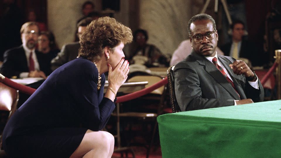 Clarence Thomas listens to his wife Virginia during a break in hearings before the Senate Judiciary Committee in Washington on October 12, 1991. - John Duricka/AP
