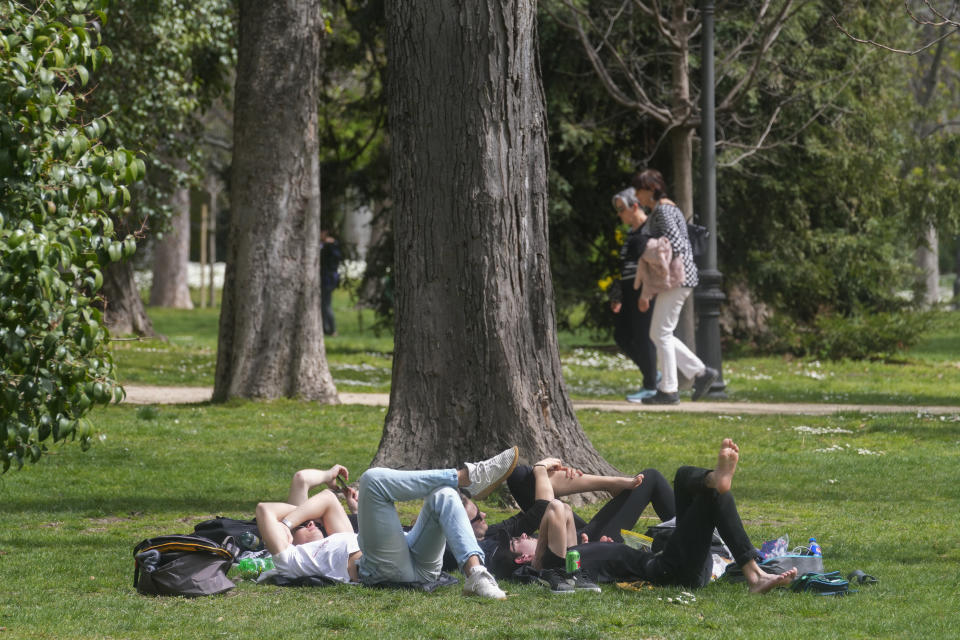 FILE - People relax in the Retiro park in Madrid, Spain, Wednesday, March 20, 2024. Another month, another heat record for the planet. Earth just had its warmest March ever recorded, the 10th month in a row to set such a record, according to the European Union climate agency Copernicus. (AP Photo/Paul White, File)