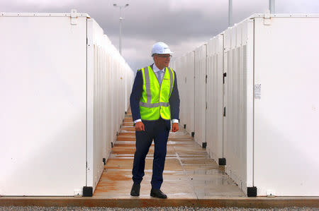 South Australian Premier, Jay Weatherill walks around the compound housing the Hornsdale Power Reserve, featuring the world's largest lithium ion battery made by Tesla, during the official launch near the South Australian town of Jamestown, in Australia, December 1, 2017. REUTERS/David Gray