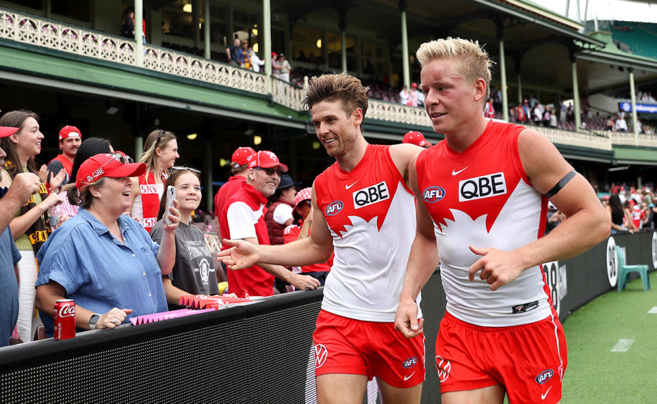 Sydney Swans players Dane Rampe and Isaac Heeney, pictured here celebrating with fans after their win over Hawthorn.