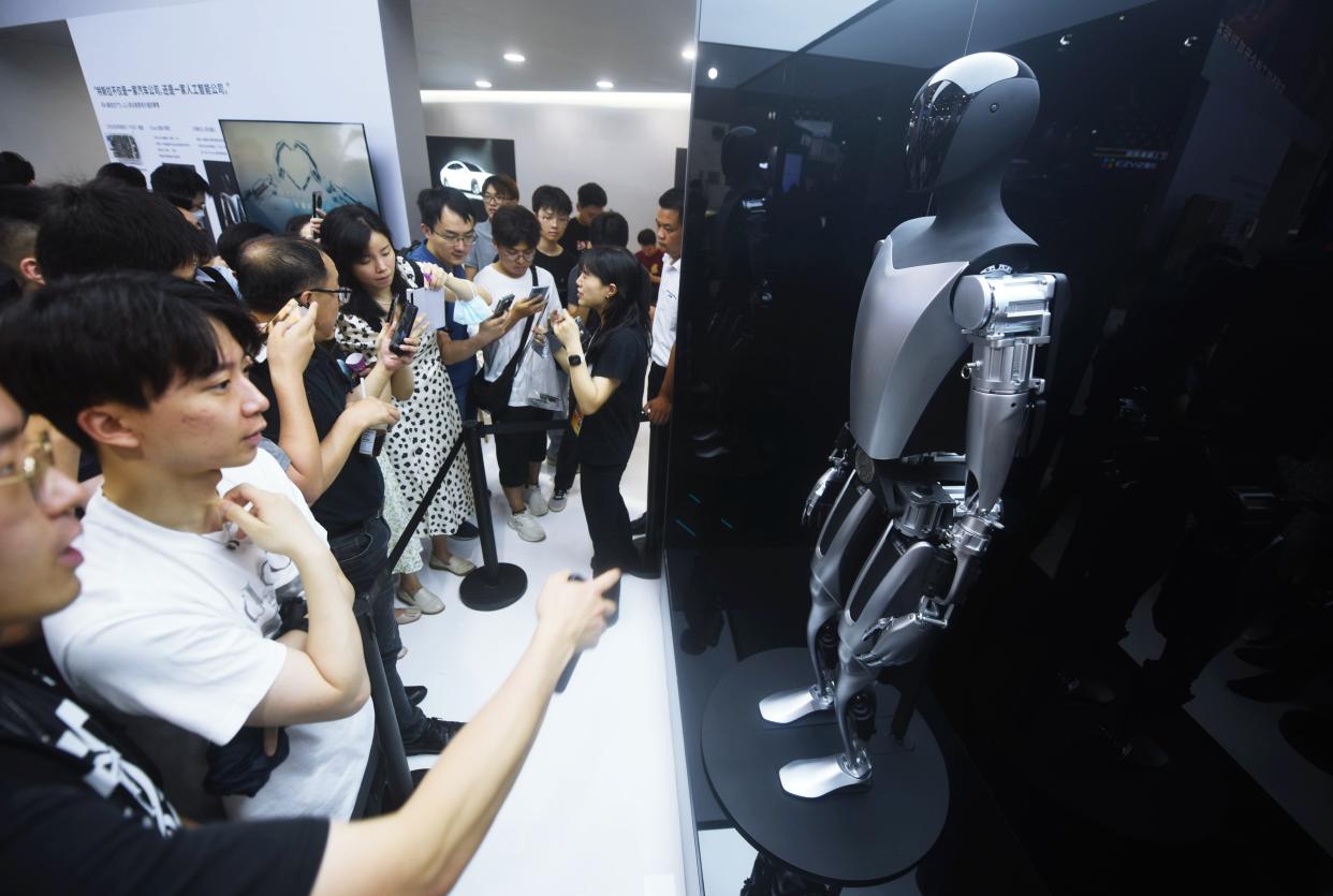 SHANGHAI, CHINA - JULY 6, 2023 - Spectators look at Tesla's 