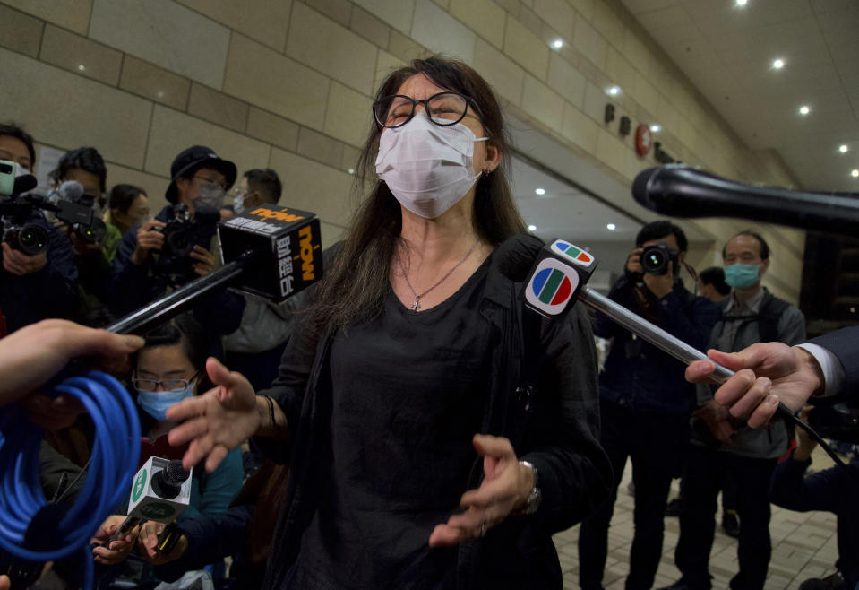 A relative of one of the 47 pro-democracy activists reacts outside a court in Hong Kong Thursday, March 4, 2021. A Hong Kong court on Thursday remanded all 47 pro-democracy activists charged under a Beijing-imposed national security law in custody, ending a four-day marathon court hearing. (AP Photo/Vincent Yu)