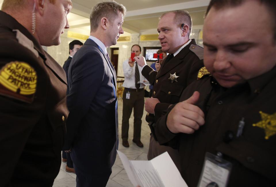 LGBT activist Troy Williams is temporarily removed by troopers from the Utah Highway Patrol, from in front of the Governor's office at the Utah State Capitol building in Salt Lake City February 10, 2014. LGBT activists are demanding the Legislature consider an anti-discrimination bill, Senate Bill 100, which the Senate has declined to do so. (REUTERS/Jim Urquhart)