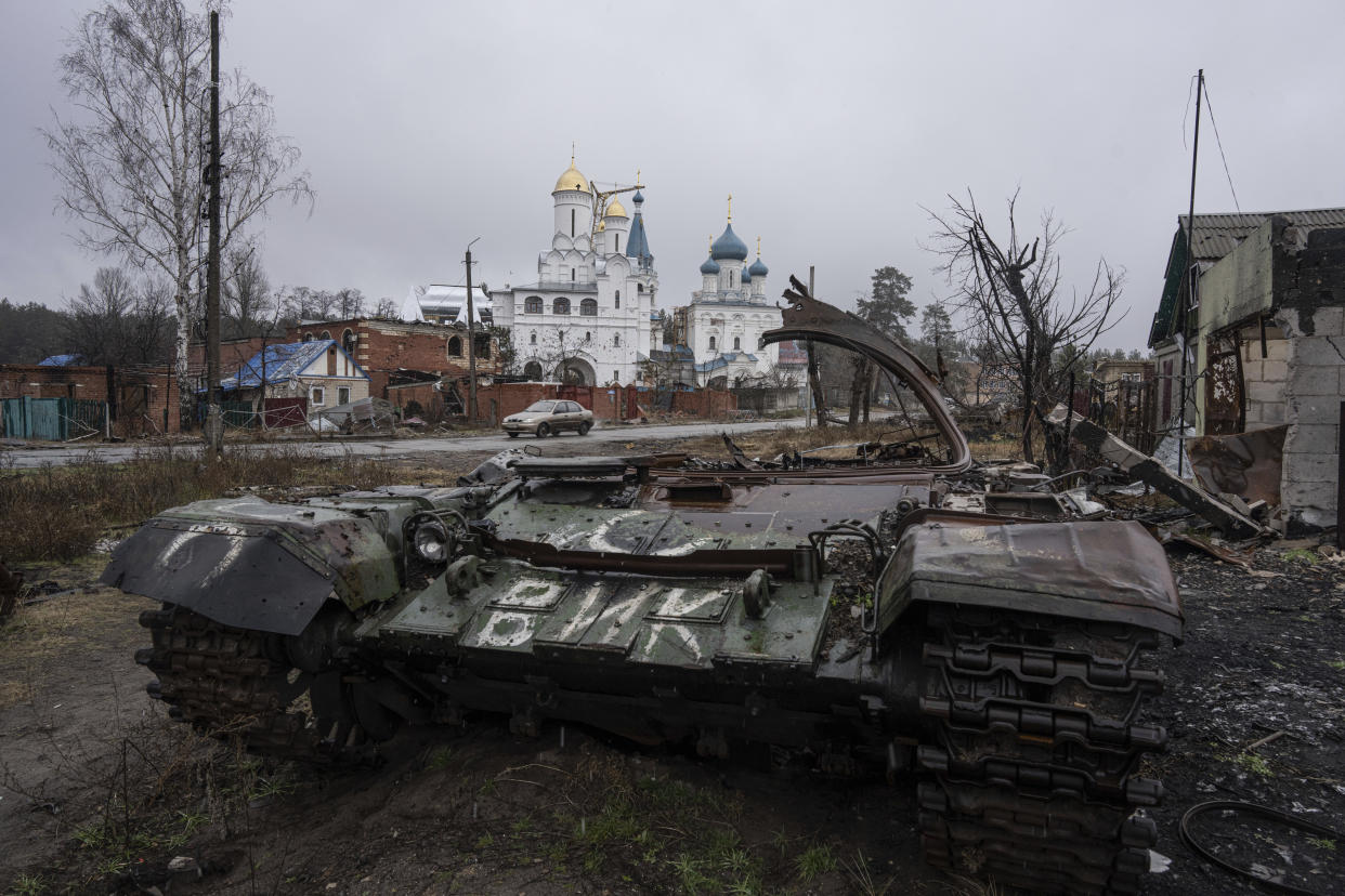 A destroyed Russian tank stands across the road of a church in the town of Sviatohirsk, Ukraine, Friday, Jan. 6, 2023. (AP Photo/Evgeniy Maloletka)