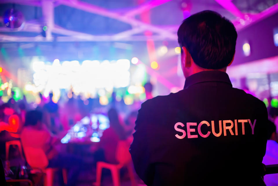 security guard looking over a busy night club