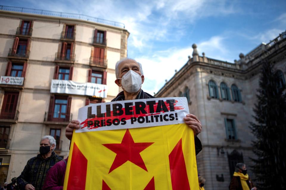 A man with a banner reading ‘Freedom for political prisoners’ in Barcelona earlier this month (EPA/ENRIC FONTCUBERTA) (EPA)