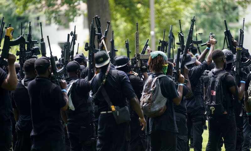 Members of an all-black militia group called NFAC prepare for a march during a rally, in Louisville